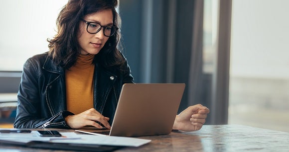 Woman with glasses on laptop