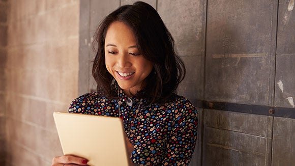 Smiling woman looking at tablet Smiling woman looking at tablet