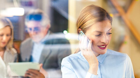 female professional on phone female professional on phone at work discussing interview questions