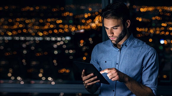 2019 Salary survey Man on tablet downloading salary survey