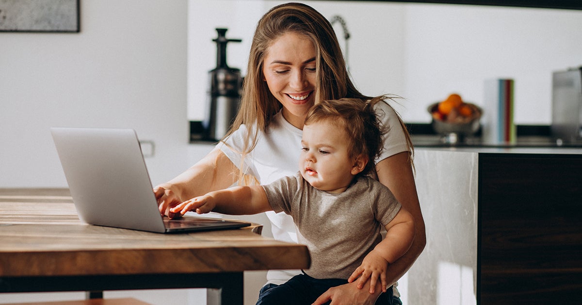woman working at home with toddler